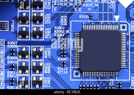 Macro shot of a Circuitboard with resistors microchips and electronic components. Computer hardware technology. Integrated communication processor. In Stock Photo