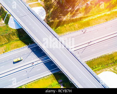 Aerial view of highway in city. Cars crossing interchange overpass. Highway interchange with traffic. Aerial bird's eye photo of highway. Expressway.  Stock Photo