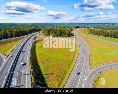 Aerial view of highway in city. Cars crossing interchange overpass. Highway interchange with traffic. Aerial bird's eye photo of highway. Expressway. 