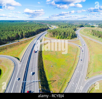 Aerial view of highway in city. Cars crossing interchange overpass. Highway interchange with traffic. Aerial bird's eye photo of highway. Expressway. 