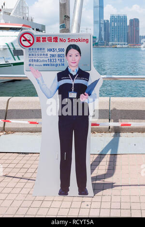 Placard with picture of woman saying no smoking beside the ferry terminal in Hong Kong Stock Photo