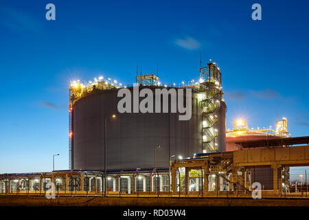 Liquefied natural gas (LNG) storage tank at dusk. Stock Photo