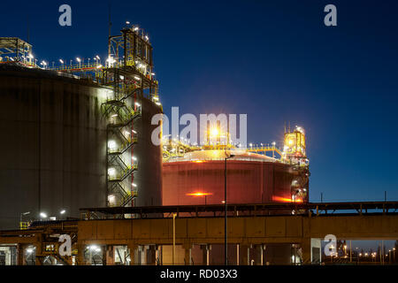 Liquefied natural gas (LNG) storage tanks at night. Stock Photo