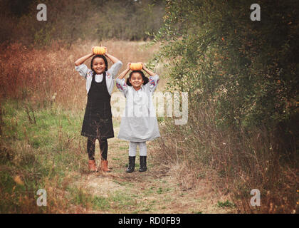 Two girls friends smiling with their arms around each other Stock Photo ...
