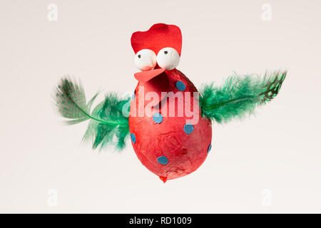 Funny handmade red chicken used for decorating an Easter egg tree, white background Stock Photo