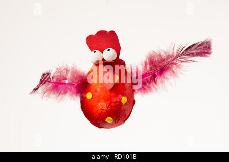 Funny handmade red chicken used for decorating an Easter egg tree, white background Stock Photo