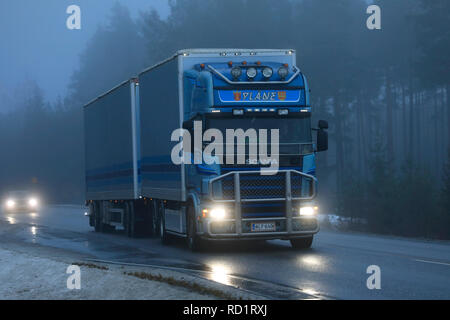 Salo, Finland - December 28, 2018: Blue Scania 4-series freight transport truck YLANE of KLV-Kuljetus moves along winter road on foggy day in Finland. Stock Photo