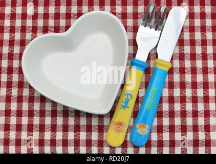 Heart Shaped Bowl and Babys' Cutlery Stock Photo