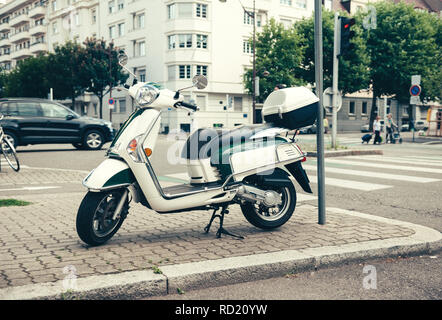 PARIS, FRANCE - JUN 27, 2015: Side view of Piaggio scooter parked on a French street  Stock Photo