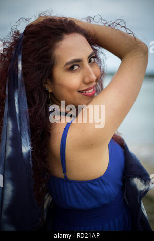 Smiling woman with her hand in her hair Stock Photo