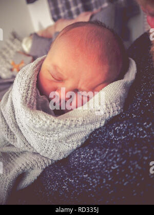 Newborn baby boy cuddling father Stock Photo