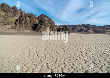 Dry lake bed formed polygon patterns, usually 6 sided, Racetrack Playa and The Grandstand Island, Death Valley National Park, California Stock Photo