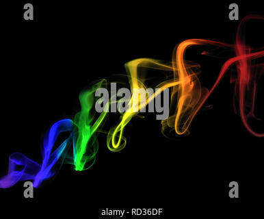 Colorfully illuminated smoke trails in the dark create beautiful bright spectrum colors on a black background. Stock Photo