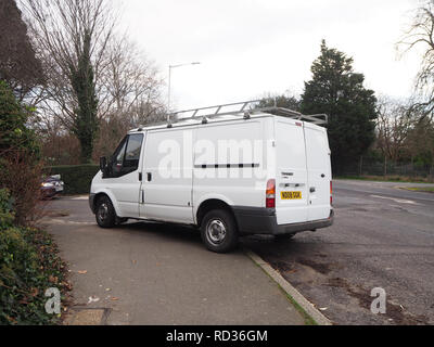 White van parked illegally on a pavement Stock Photo