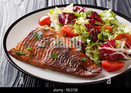 Tasty pike fillet and fresh vegetables close-up on a plate on the table. horizontal Stock Photo