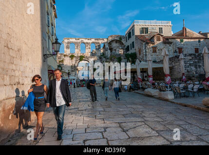 Tourists walk along an old paved road in the old Roman city of Split, on the Dalmatian Coast, Croatia Stock Photo