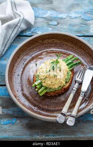 Toast with scrabled eggs and avocado, copy space Stock Photo