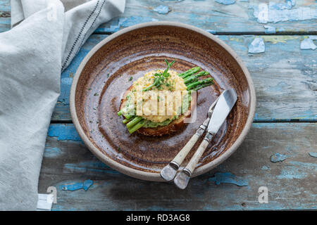 Healthy breakfast with scrambled eggs, avocado and asparagus, close view Stock Photo