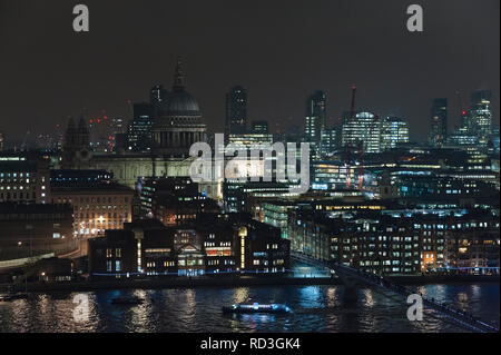 London, UK. Night view across the River Thames from Tate Modern, showing St Paul's Cathedral in the heart of the City, London's financial district Stock Photo