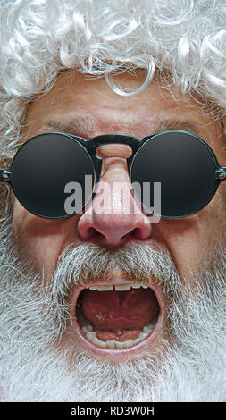 Portrait of happy smiling Santa Claus. Christmas celebration concept. The emotional face of Santa Clause in glasses. The holiday, expression, emotions Stock Photo