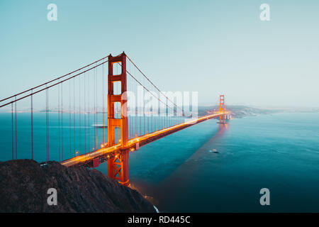 Panoramic view of famous Golden Gate Bridge seen from Battery Spencer viewpoint in post sunset twilight during blue hour at dusk, San Francisco, USA Stock Photo