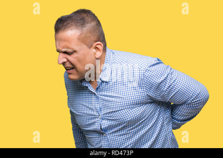 Middle age arab business man over isolated background Suffering of backache, touching back with hand, muscular pain Stock Photo