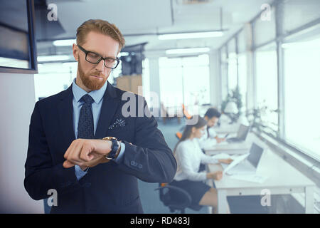 Man looks at his watch Stock Photo