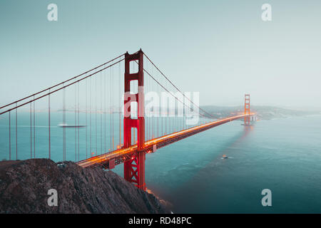 Panoramic view of famous Golden Gate Bridge seen from Battery Spencer viewpoint in beautiful post sunset twilight during blue hour at dusk, San Franci Stock Photo