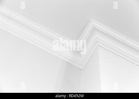 White interior fragment with corner and decorative ceiling baseboard Stock Photo