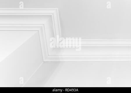 Abstract white interior fragment with walls and decorative ceiling baseboard Stock Photo