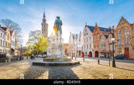 Scenic view of historical Brugge city center with famous Jan van Eyck square in beautiful golden evening light, Flanders region, Belgium Stock Photo