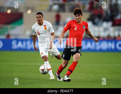 16th January 2019, Al-Nahyan Stadium, Abu Dhabi, United Arab Emirates; AFC Asian Cup football, South Korea versus China; Kim Min-jae of South Korea passing the ball in front of Zhao Xuri of China Stock Photo