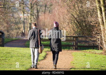 Kidderminster, UK. 17th January, 2019. UK weather: after a cold start with temperatures only just above freezing, the morning sun here is a welcome sight for all in Kidderminster. In spite of the sunshine, daytime temperatures are forecast to peak at only 5 degrees celsius with another cold night ahead. This couple take time out to walk in a country park and enjoy some welcome winter sunlight. Credit: Lee Hudson/Alamy Live News Stock Photo