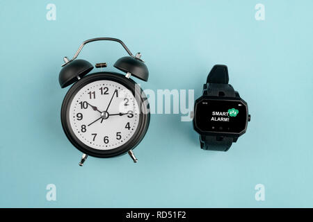 Analog alarm clock against watch Stock Photo