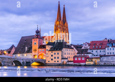 Regensburg, Germany, historical Stone Bridge, Bridge tower and buildings in the evening.