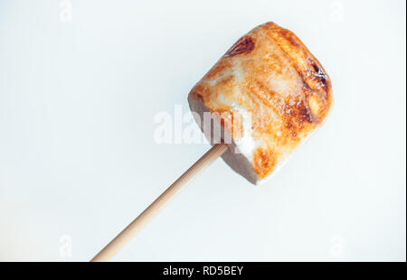 roasted marshmallows on a skewer on white background. Stock Photo