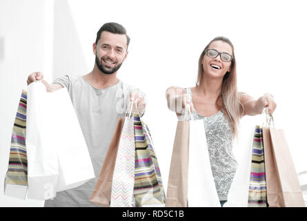 happy husband and wife showing their shopping bags Stock Photo