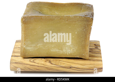olive oil based hand-cut soap on underlay made of olive wood isolated on white background Stock Photo