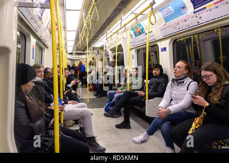 London, UK - April 30, 2018: Commuters travel by the circle line tube train Stock Photo