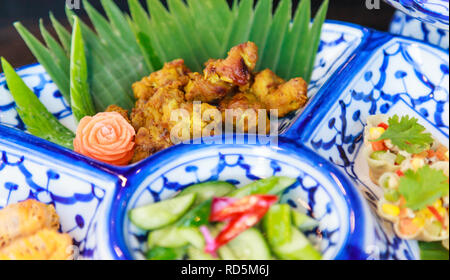 Traditional Thai Food Dish: Turmeric, garlic and black pepper fried chicken wings. Thailand Cultural Street Food, Delicious cuisine dish rich with med Stock Photo