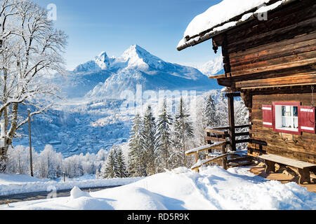 Beautiful view of traditional wooden mountain cabin in scenic winter wonderland mountain scenery in the Alps Stock Photo