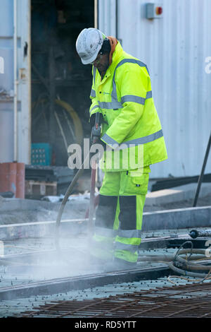 Workmen on the Blackpool Tramway extension joining the route along the promenade along Talbot Square, with a new tracks and terminal, UK Stock Photo