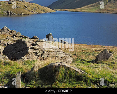 spectacular landscape with rocks looking over Small Water en route from Haweswater up to High Street in the Lakeland Fells, Cumbria, England, UK Stock Photo