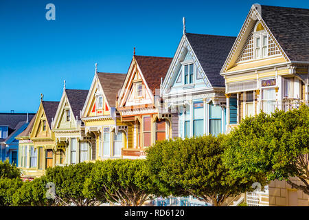 Famous Painted Ladies, a row of colorful Victorian houses located near scenic Alamo Square, on a beautiful sunny day, San Francisco, USA Stock Photo