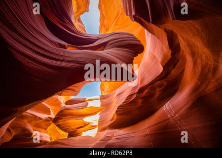 Beautiful wide angle view of amazing sandstone formations in famous Antelope Canyon on a sunny day with blue sky near the old town of Page at Lake Pow Stock Photo