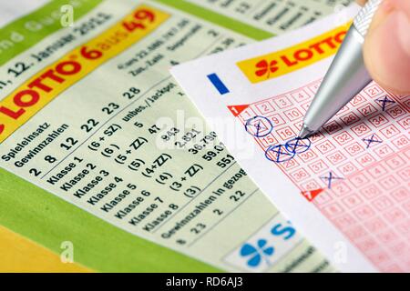 Lottery, check the winning numbers, 6 from 49, number rows Stock Photo