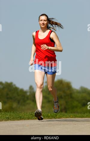 Recreational runner, young woman, 25-30 years, jogging Stock Photo
