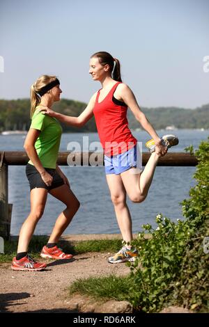 Young women, 25 - 30 years, stretching excercises Stock Photo