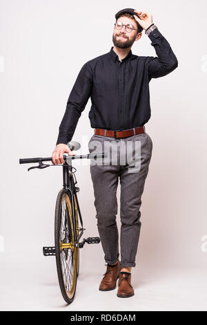 Portrait of a bearded man walking with fixie bicycle over white background Stock Photo