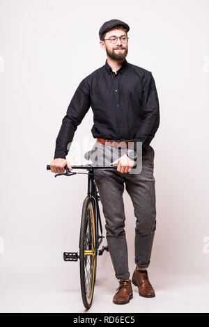 Portrait of a bearded man walking with fixie bicycle over white background Stock Photo